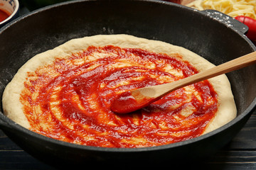 Unbaked pizza in pan, closeup