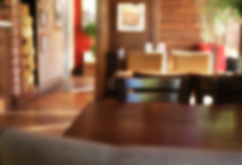 Blurred view of table and chairs in cafe