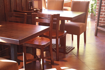 Wooden table and chairs in modern cafe