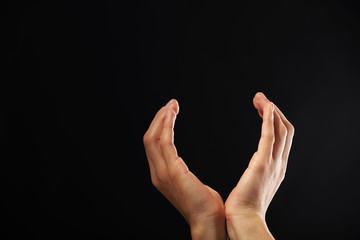Male hands on dark background
