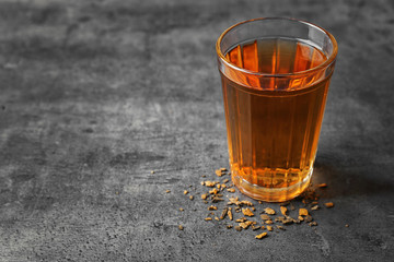 Water shortage concept. Glass of dirty water on grey background