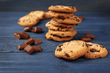 Tasty chocolate cookies on wooden table