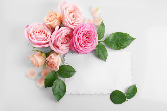 Floral composition with paper card on white background