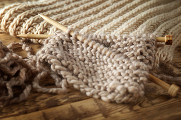 Fototapeta na wymiar Knitting yarn and needles on wooden background, closeup