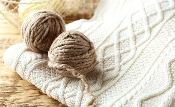 Grey balls of knitting yarn on knitwear, closeup