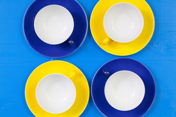 Symmetry  arrangement empty cups of tea on blue wooden table