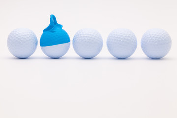 White golf balls with funny cap on the white background.