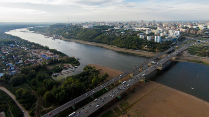 Autumn in city. Panoramic aerial view at road, forest, river.