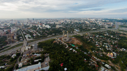 Autumn in city. Panoramic aerial view at road, forest, river.