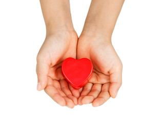 Heart care, medical concept. Heart in the hands of a child. Isolated on white.