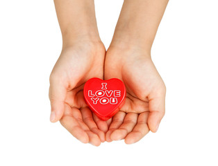 Heart care, medical concept. Heart in the hands of a child. Isolated on white.