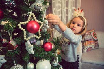 Child decorating Christmas tree