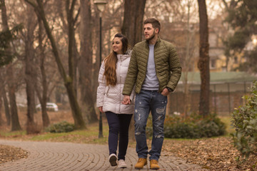 Fototapeta premium Young couple walking winter autumn day