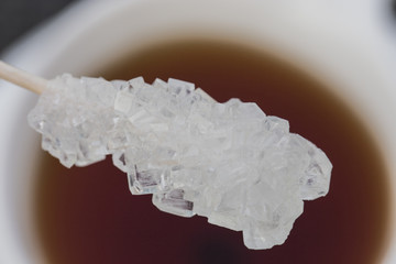 Sticks to crystallize brown and white sugar on a white backgroun