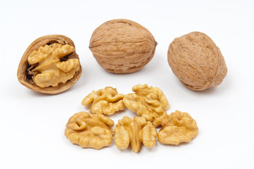 Walnuts and walnut kernels on white background
