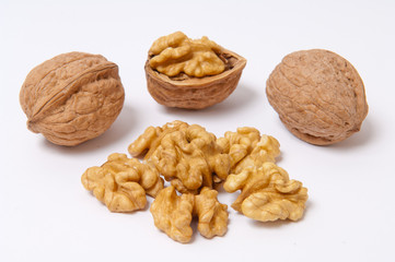 Walnuts and walnut kernels on white background