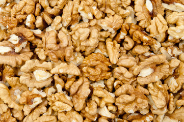 Closeup of shelled walnuts pile walnut background
