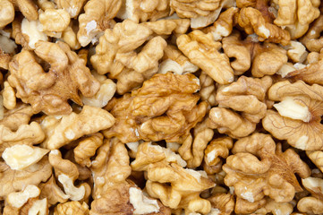 Closeup of shelled walnuts pile walnut background