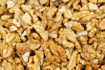 Closeup of shelled walnuts pile walnut background