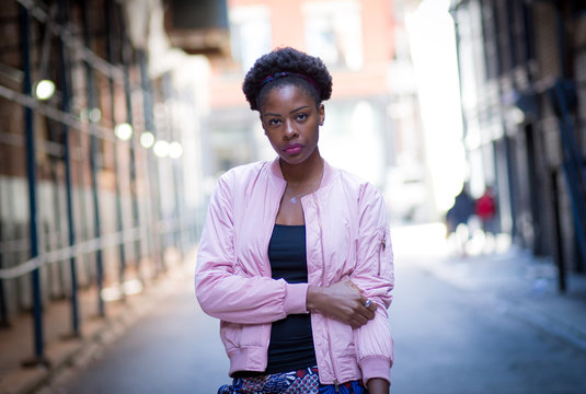 Portrait of young black woman on city street