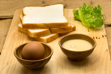 Pile of sliced breads, sweetened condensed milk and egg