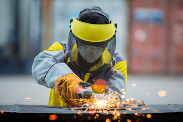 Employee grinding steel with sparks