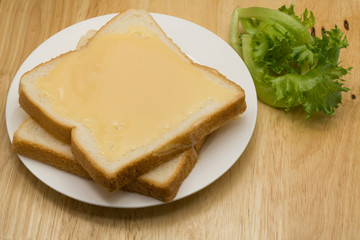 Breads and sweetened condensed milk in a white plate