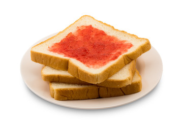 Pile of sliced bread with strawberry jam in a plate