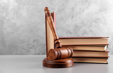 Judge's gavel and books on wall background