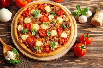 Wall murals Pizzeria Fresh pizza with tomatoes, cheese and mushrooms on wooden background