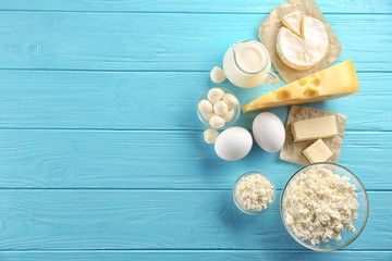 Dairy products on wooden background, top view