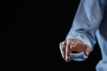 Businessman hand pointing, black background