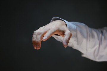 Businessman hand on dark background