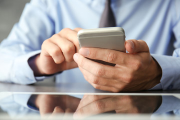 Businessman using phone  on table