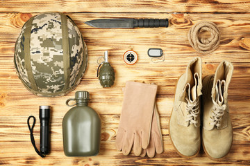 Military equipment on wooden background