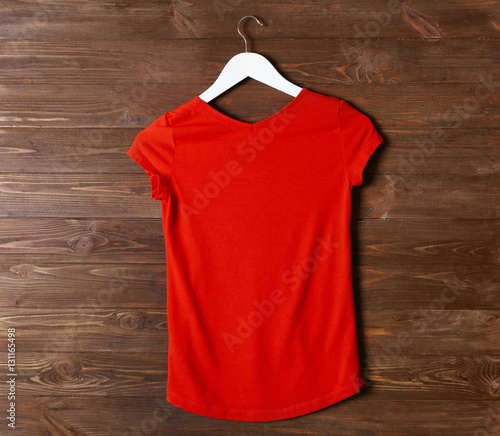 “Blank red t-shirt against wooden background” Stock photo and royalty