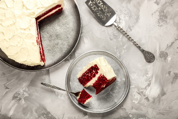 Slice of delicious red velvet cake on table