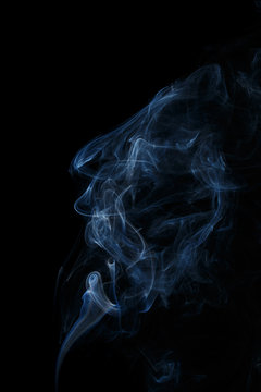 Abstract art. Color white blue smoke from the aromatic sticks on a black background. Background for Halloween. Texture fog. Design element. The concept of aromatherapy.