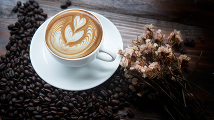 A Cup of Coffee and Coffee Beans with Dried Flowers