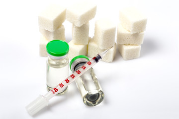 Refined sugar as the main cause of diabetes. Two medical ampules with insulin hormone. Insulin...