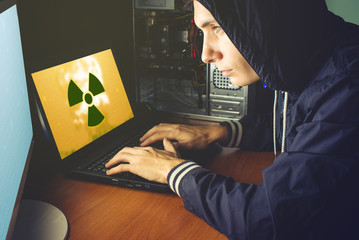 young hacker in the dark infect computers and systems