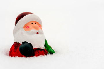 Tree toy Santa Claus in the snow