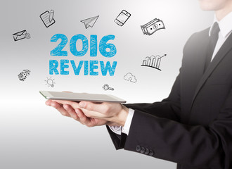 2016 Review concept, young man holding a tablet computer