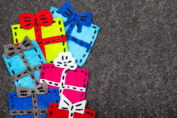 Christmas gifts on grey background.  Felt Christmas ornaments with copy space