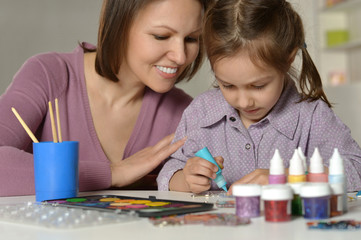 mother doing homework with daughter