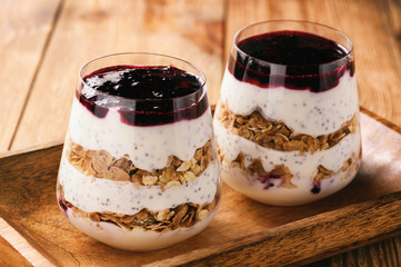 Yogurt dessert with chia seeds, muesli and black currant jam.