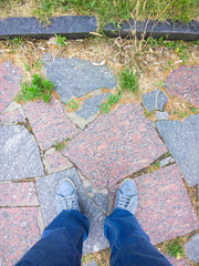 Feet on the cobblestone.