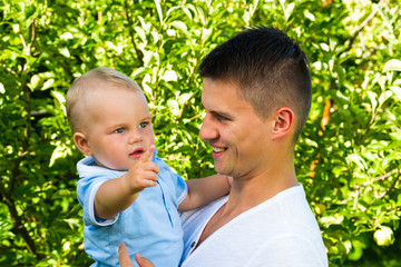 charming caucasian baby boy with father