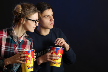 Young couple watching a movie in the cinema.