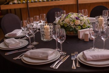 covered with a black cloth festive table and glasses in a restaurant